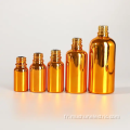 Bouteille en verre d'huile essentielle vide de cylindre en or vide